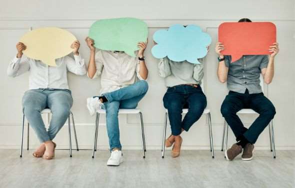 Four people sitting in chairs covering their faces being anonymous.