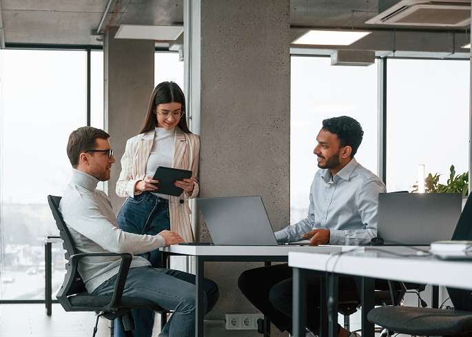 photo of professionals in an office with computers