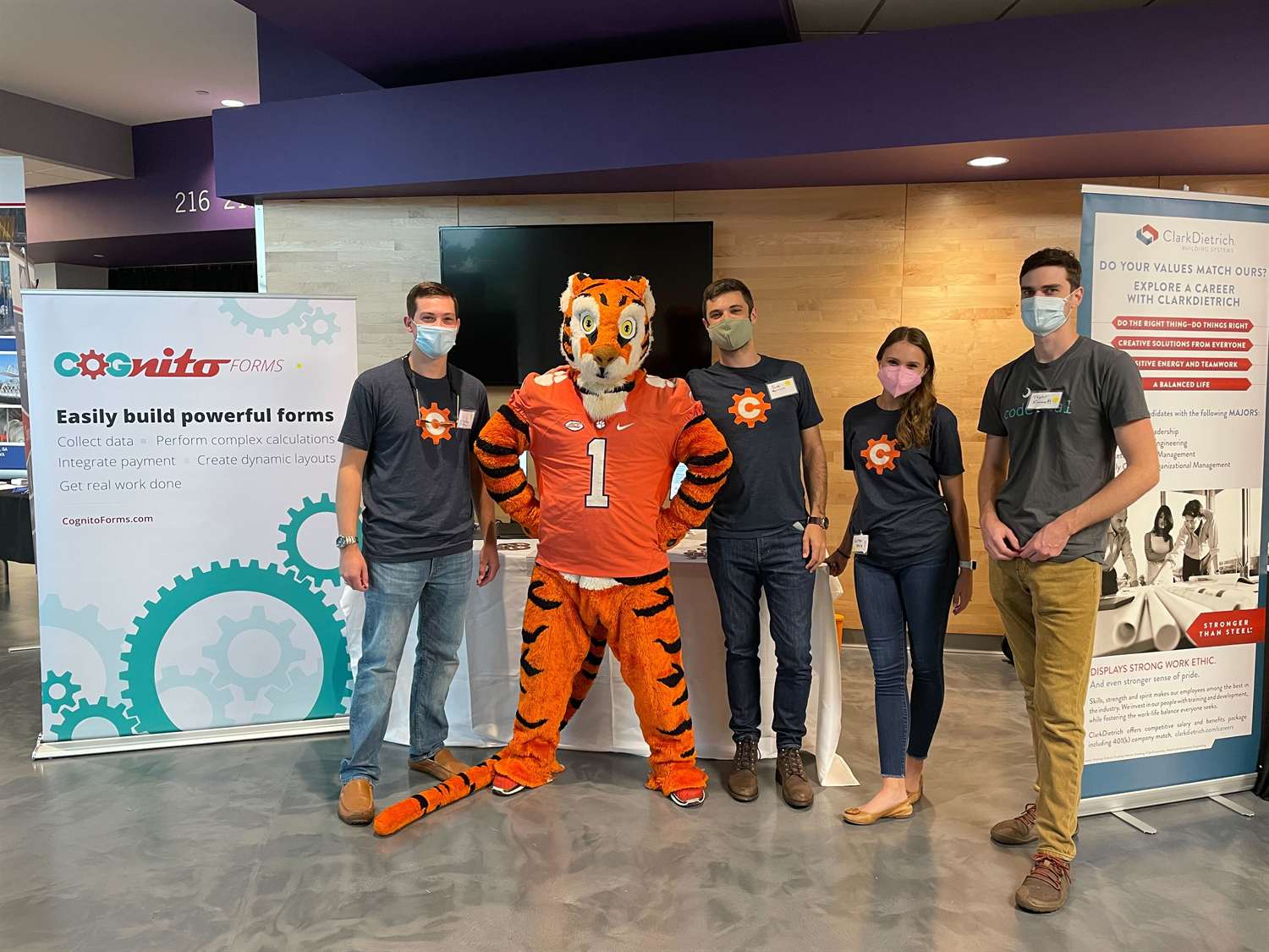 A group photo featuring the Cognito Forms team with the Clemson Tiger mascot at a career fair.