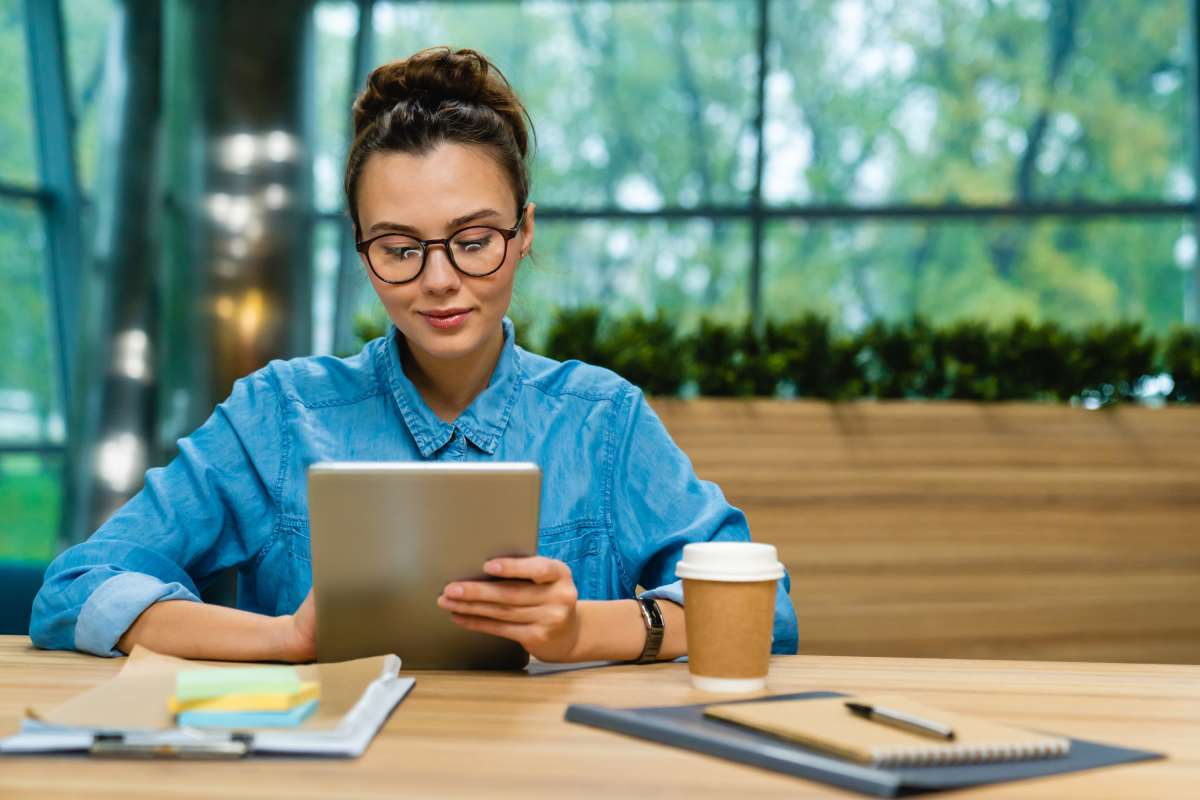 woman in glasses filling out online intake form