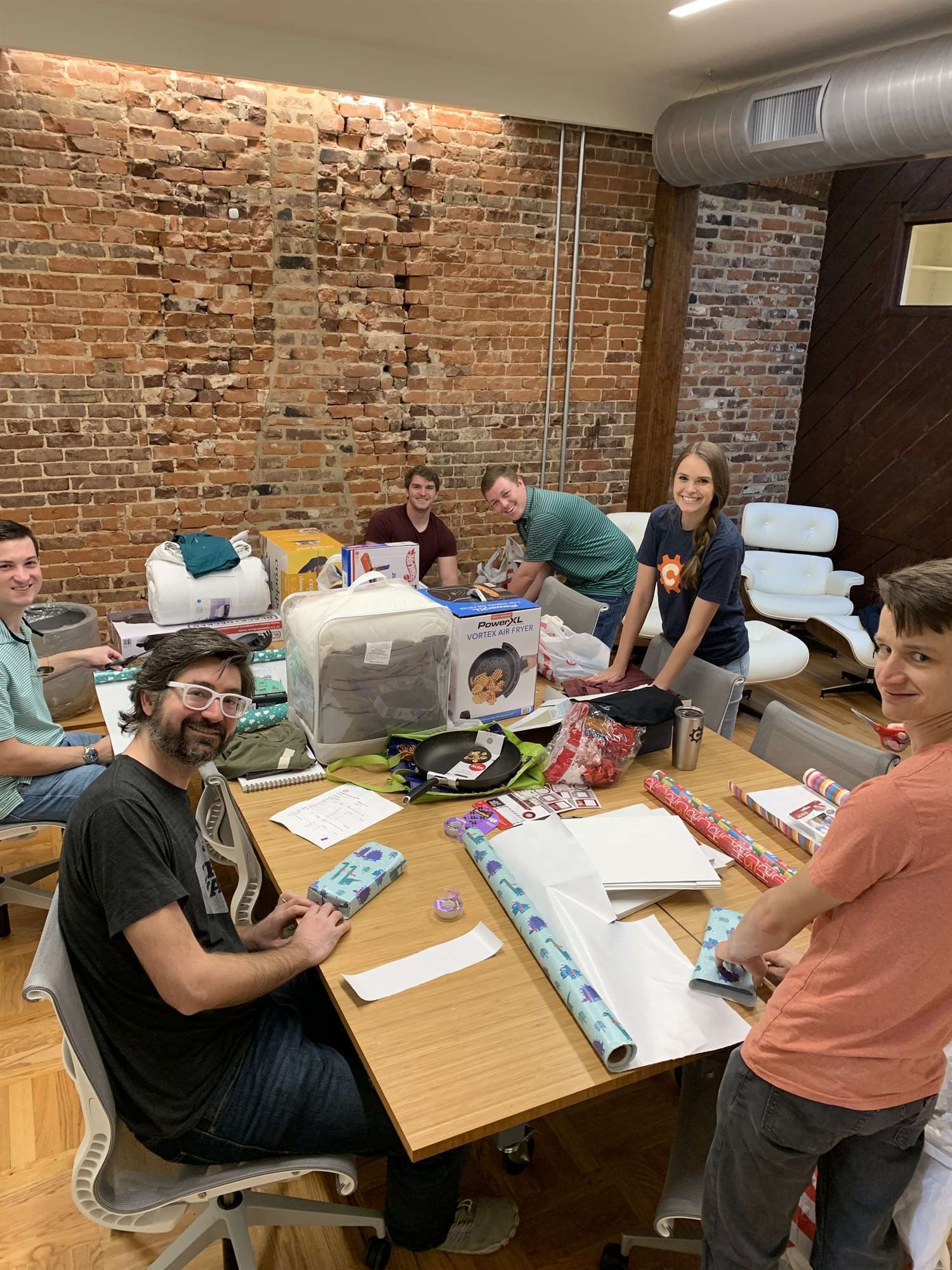 Cognito Forms employees wrapping Christmas presents