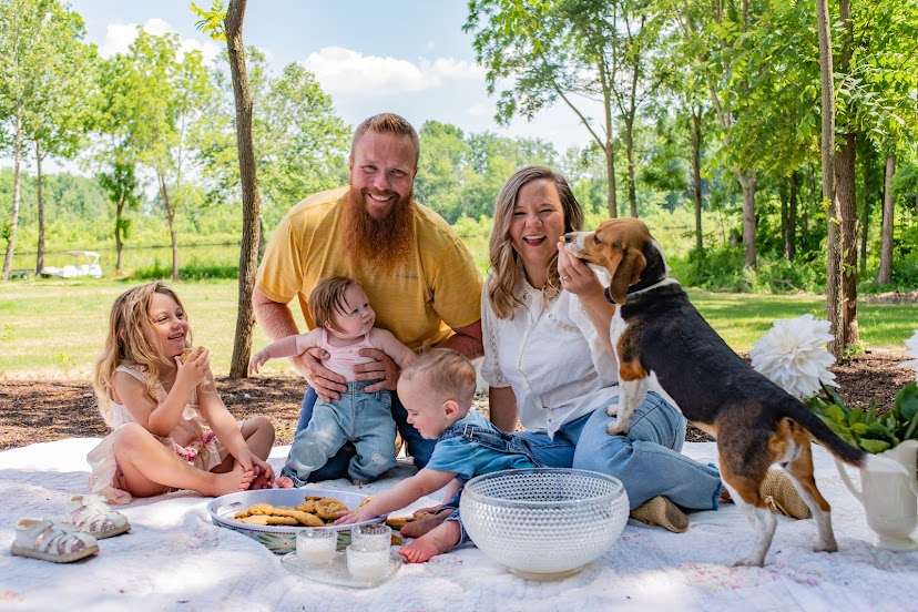 family_photo_on_picnic_blanket_with_dog.jpg