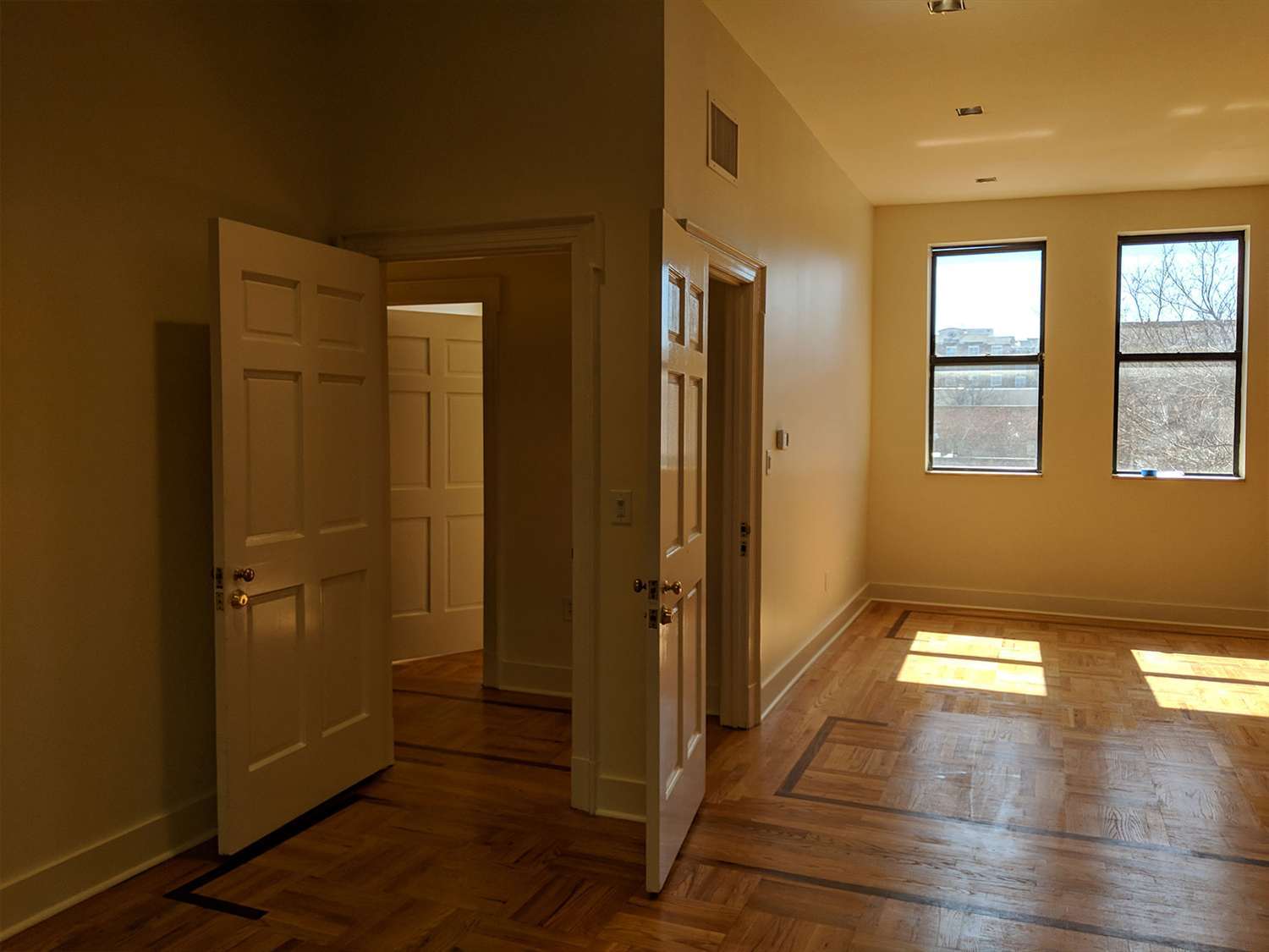 a hallway connects the main room to another large work area
