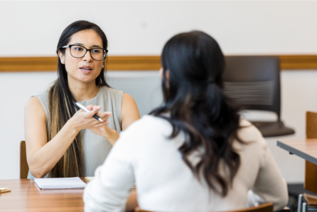 A woman conducting a performance appraisal with an employee.