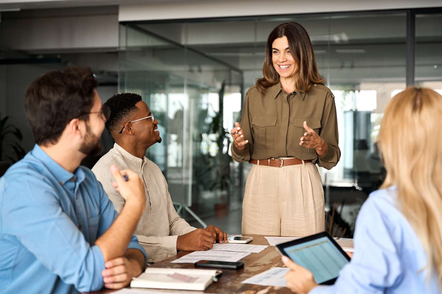 Woman leading discussion with sales team in meeting