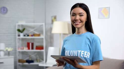 Volunteer holding tablet while fundraising.