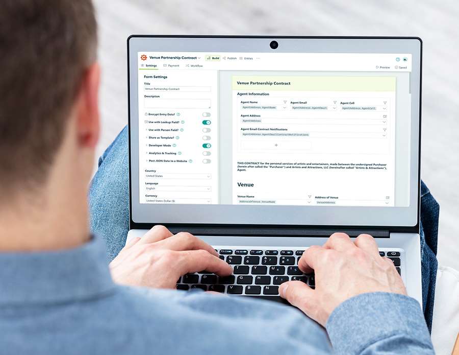 Man working with Cognito Forms on a laptop
