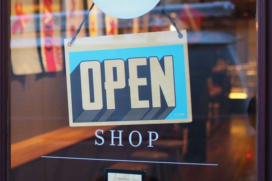 Open sign on the door of a shop.