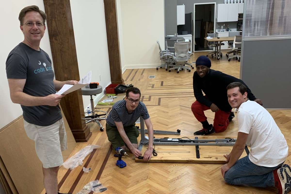 Cognito team assembling desks.