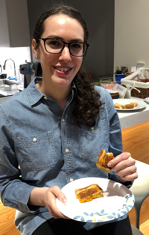 Nadia Shamy eating a grilled cheese.