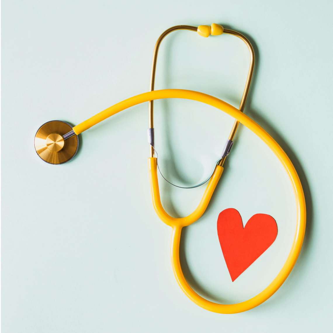 yellow stethoscope and heart