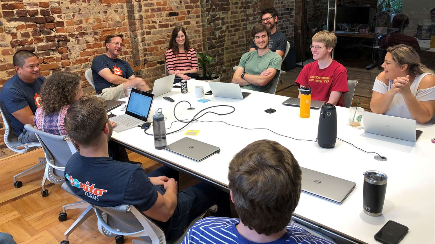 Jamie Thomas, CEO and Co-Founder of Cognito Forms, hosting a meeting with a group of employees.