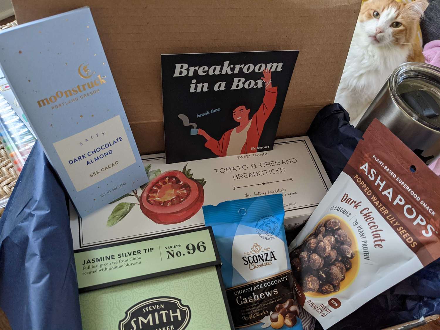 A box of packaged snacks and gifts labeled as Breakroom in a Box.