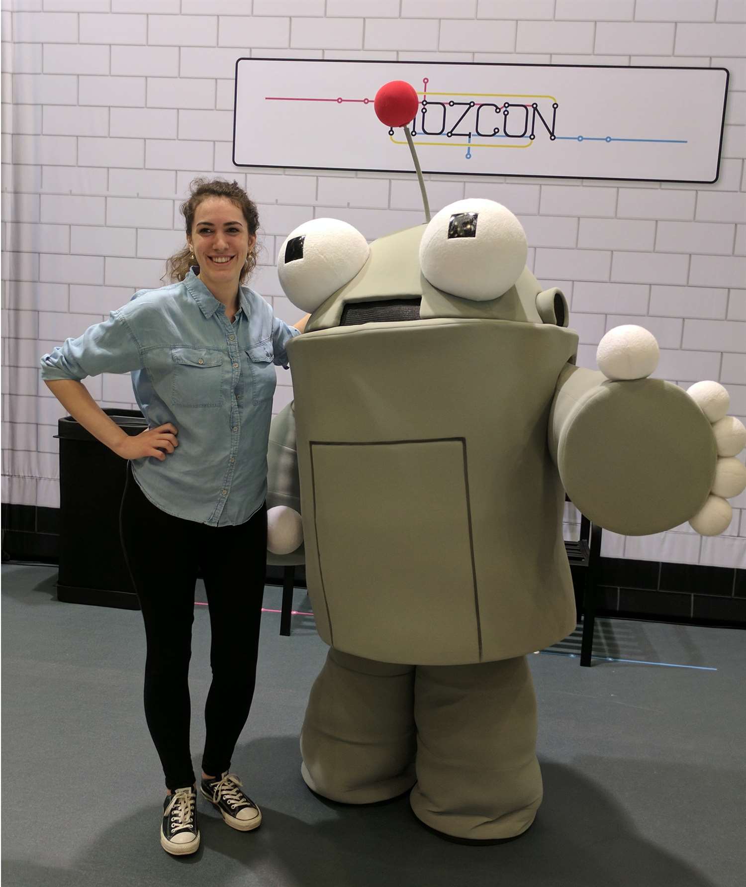Nadia posing with Roger, a robot mascot, at MozCon.